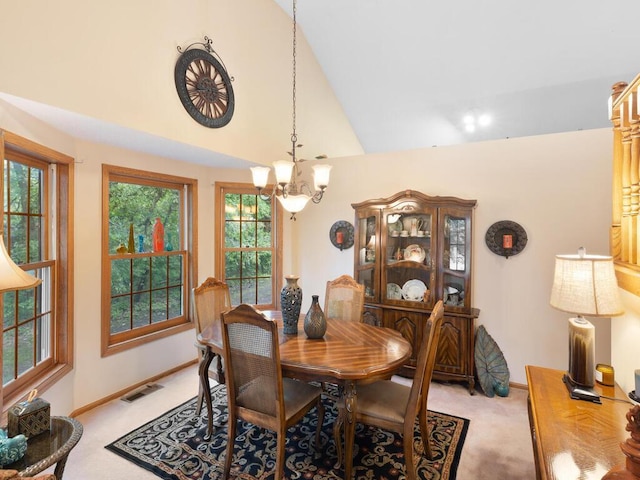 9160 164th Ln NW, Ramsey, MN 55303 - dining space with light carpet, a chandelier, high vaulted ceiling, and baseboards