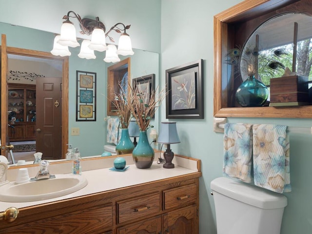9160 164th Ln NW, Ramsey, MN 55303 - half bathroom featuring vanity, toilet, and a chandelier