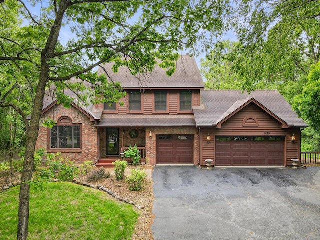 9160 164th Ln NW, Ramsey, MN 55303 - view of front of home with a shingled roof, asphalt driveway, an attached garage, and a front lawn