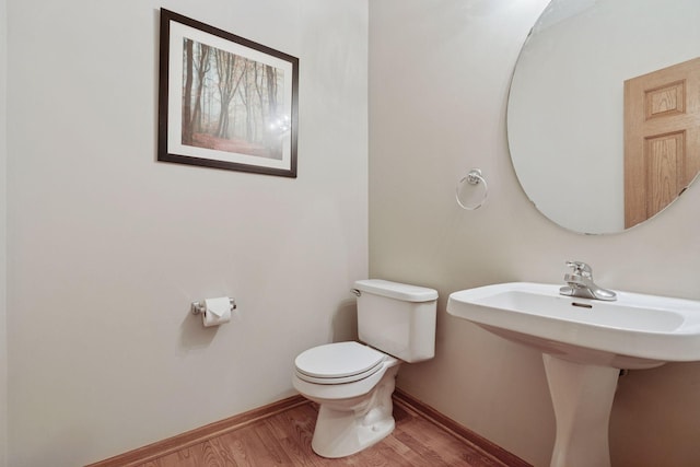 1848 111th Ave NE, Blaine, MN 55449 - bathroom with toilet, wood finished floors, baseboards, and a sink