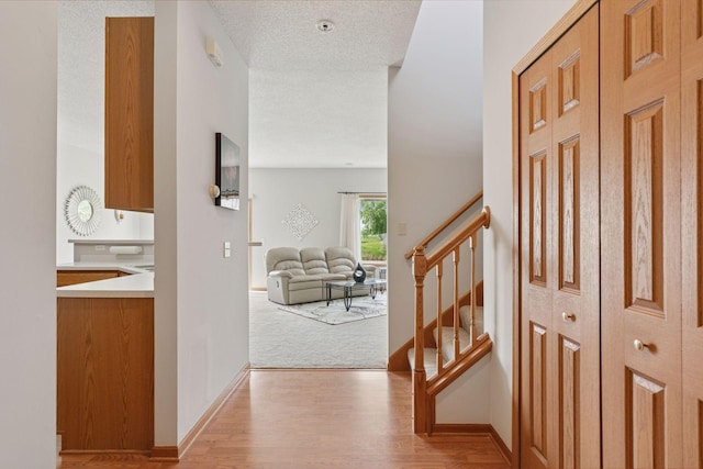 1848 111th Ave NE, Blaine, MN 55449 - hallway with stairway, light wood-type flooring, and baseboards
