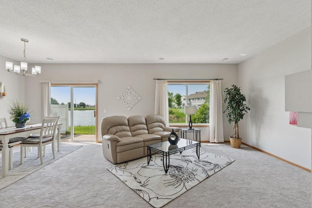 1848 111th Ave NE, Blaine, MN 55449 - living area with light carpet, a chandelier, a textured ceiling, plenty of natural light, and a water view