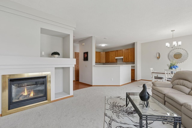 1848 111th Ave NE, Blaine, MN 55449 - carpeted living area with a chandelier, a glass covered fireplace, and baseboards