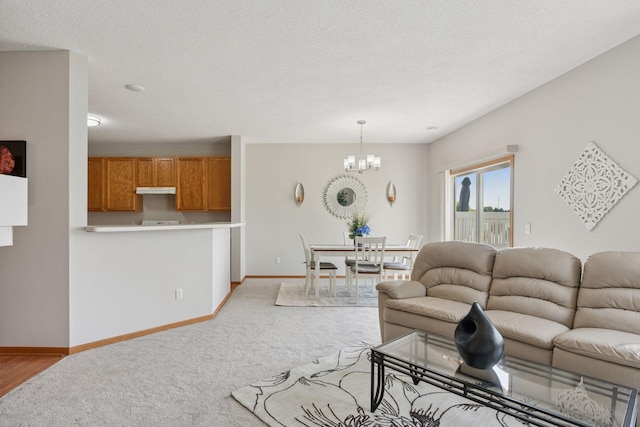 1848 111th Ave NE, Blaine, MN 55449 - living area with carpet flooring, a chandelier, baseboards, and a textured ceiling
