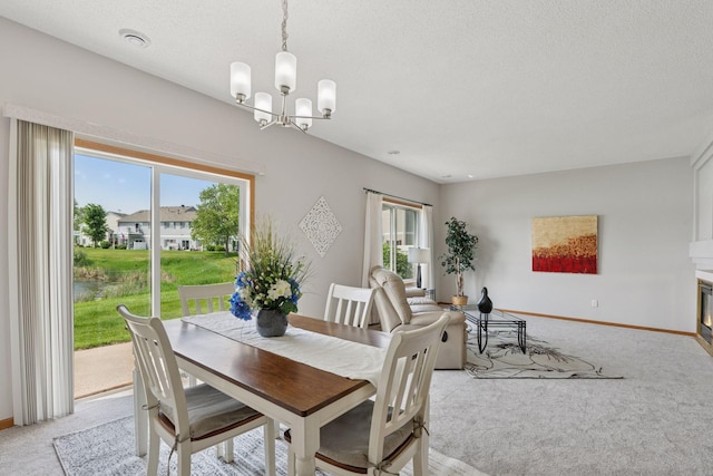 1848 111th Ave NE, Blaine, MN 55449 - dining space with light colored carpet, a chandelier, baseboards, and a textured ceiling