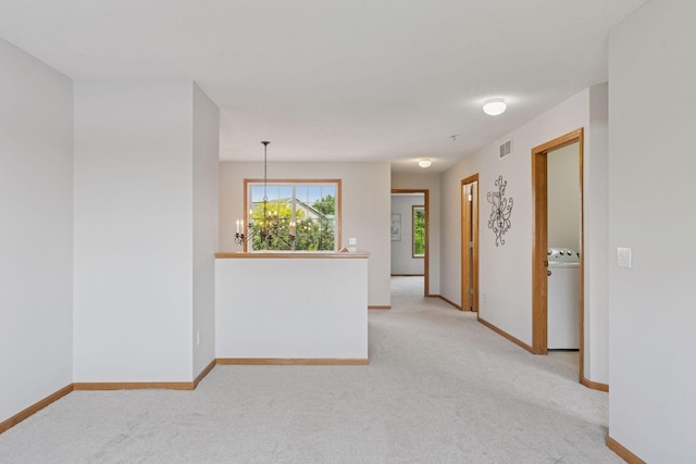 1848 111th Ave NE, Blaine, MN 55449 - empty room featuring washer / dryer, light carpet, a chandelier, and baseboards