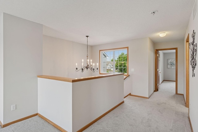 1848 111th Ave NE, Blaine, MN 55449 - hallway featuring carpet flooring, a chandelier, baseboards, an upstairs landing, and a textured ceiling