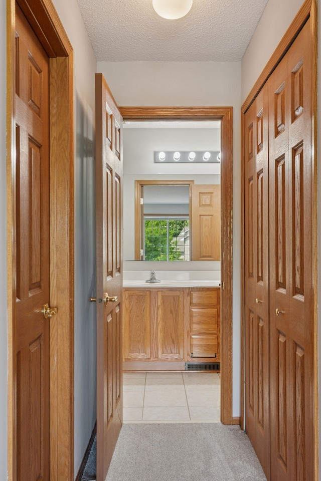 1848 111th Ave NE, Blaine, MN 55449 - bathroom featuring a textured ceiling, a closet, and tile patterned flooring