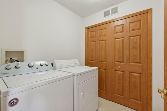 1848 111th Ave NE, Blaine, MN 55449 - laundry room with washer and dryer and a textured ceiling