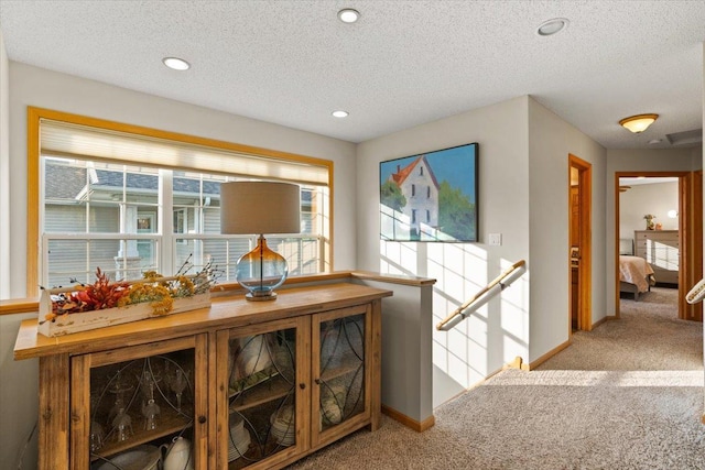 1107 Golden Way NW, Isanti, MN 55040 - hall featuring carpet, an upstairs landing, a textured ceiling, recessed lighting, and baseboards