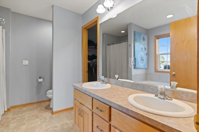 1107 Golden Way NW, Isanti, MN 55040 - full bathroom with toilet, double vanity, baseboards, a spacious closet, and a tub to relax in