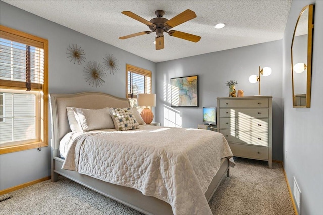 1107 Golden Way NW, Isanti, MN 55040 - bedroom featuring carpet, baseboards, a textured ceiling, and ceiling fan