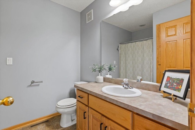 1107 Golden Way NW, Isanti, MN 55040 - bathroom featuring vanity, a textured ceiling, toilet, baseboards, and tile patterned flooring