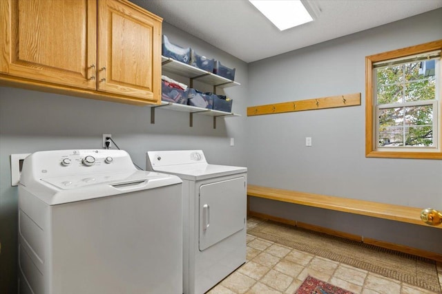 1107 Golden Way NW, Isanti, MN 55040 - laundry area with cabinet space, washer and clothes dryer, and stone finish flooring
