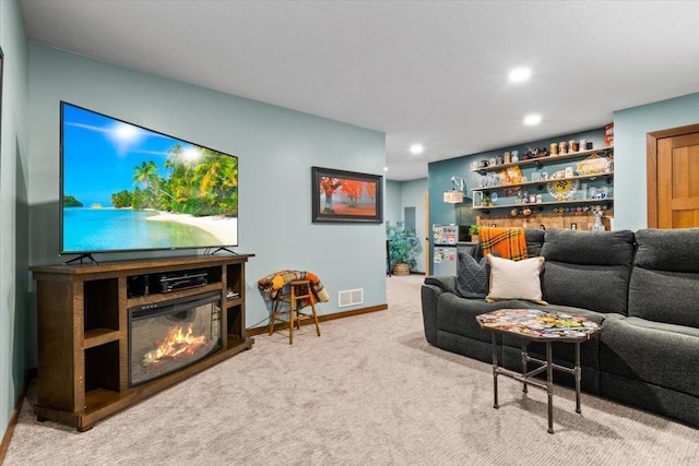 1107 Golden Way NW, Isanti, MN 55040 - living room featuring carpet, recessed lighting, a glass covered fireplace, and baseboards