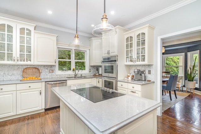 8167 Galway Cir, Woodbury, MN 55125 - kitchen with stainless steel appliances, a sink, healthy amount of natural light, decorative backsplash, and crown molding
