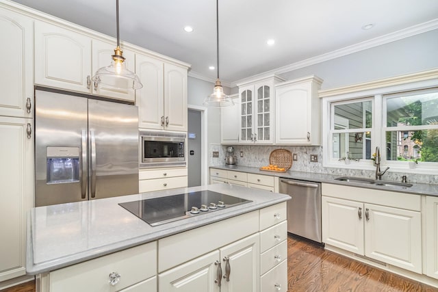 8167 Galway Cir, Woodbury, MN 55125 - kitchen with appliances with stainless steel finishes, a sink, crown molding, tasteful backsplash, and glass insert cabinets