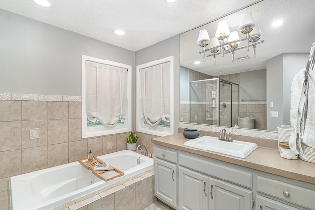 8167 Galway Cir, Woodbury, MN 55125 - full bath featuring a tub with jets, a stall shower, vanity, a chandelier, and recessed lighting