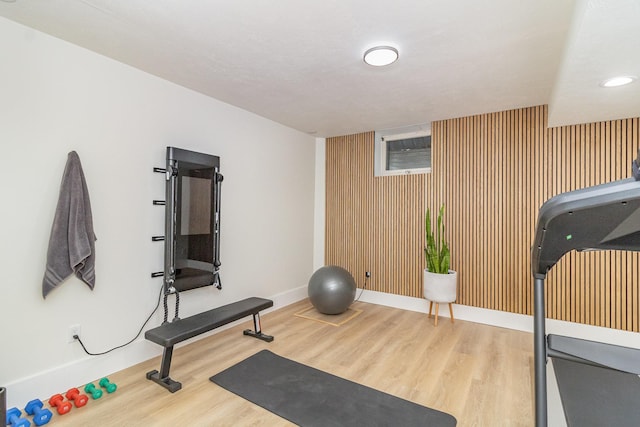 8167 Galway Cir, Woodbury, MN 55125 - workout area featuring wood finished floors, baseboards, an accent wall, recessed lighting, and wooden walls