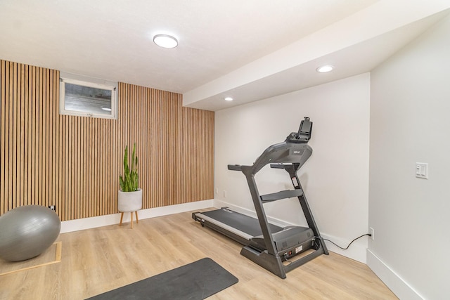 8167 Galway Cir, Woodbury, MN 55125 - workout room featuring wood finished floors, baseboards, recessed lighting, and an accent wall