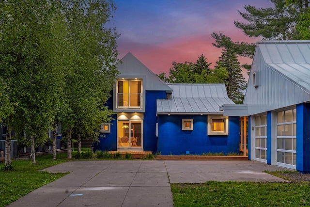 303 77th St, Chanhassen, MN 55317 - view of front facade featuring a standing seam roof, metal roof, stucco siding, and a front lawn
