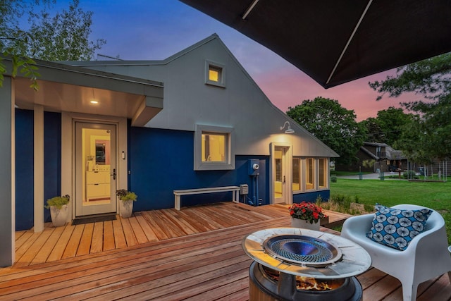 303 77th St, Chanhassen, MN 55317 - deck at dusk with an outdoor fire pit and a yard