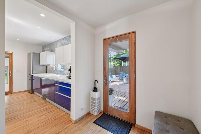 303 77th St, Chanhassen, MN 55317 - doorway with light wood-style flooring, recessed lighting, and baseboards