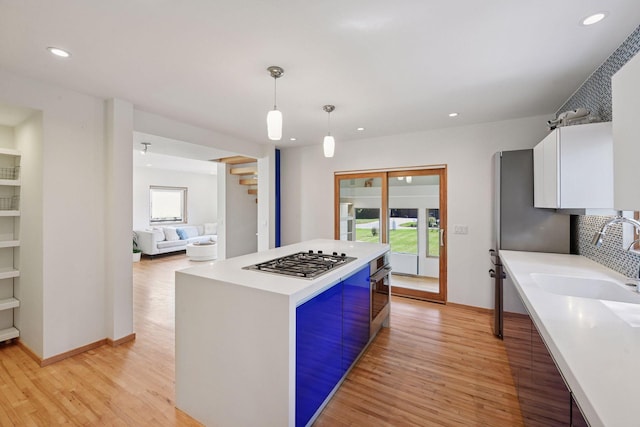 303 77th St, Chanhassen, MN 55317 - kitchen featuring stainless steel appliances, a sink, light wood-style floors, healthy amount of natural light, and recessed lighting