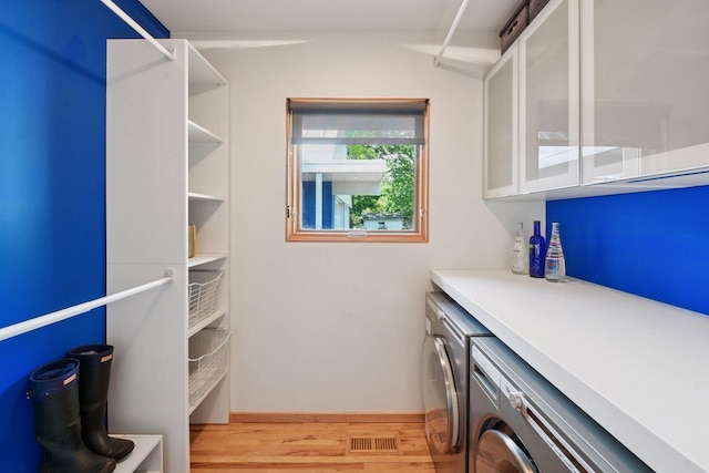 303 77th St, Chanhassen, MN 55317 - laundry area with washer and dryer, light wood finished floors, and baseboards