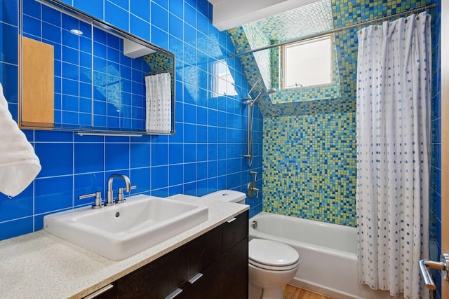 303 77th St, Chanhassen, MN 55317 - bathroom featuring shower / bath combo with shower curtain, toilet, vanity, and tile walls
