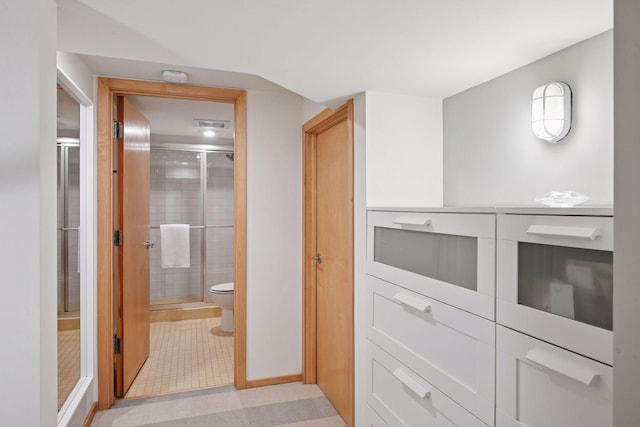 303 77th St, Chanhassen, MN 55317 - hallway featuring light tile patterned flooring and baseboards