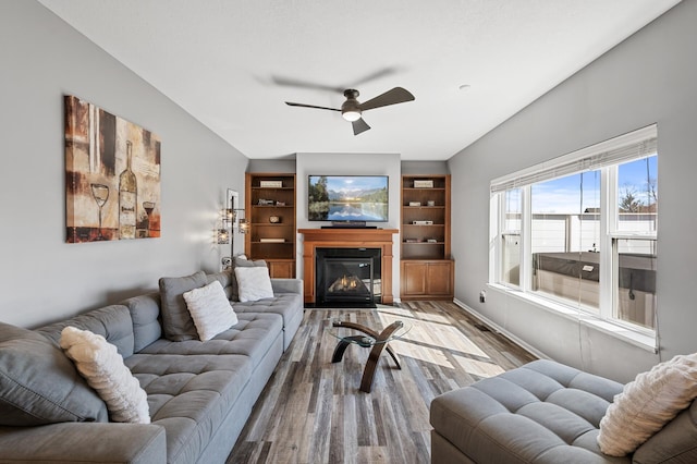 3297 Thornton Dr SW, Prior Lake, MN 55372 - living room featuring ceiling fan, wood finished floors, and a fireplace with flush hearth