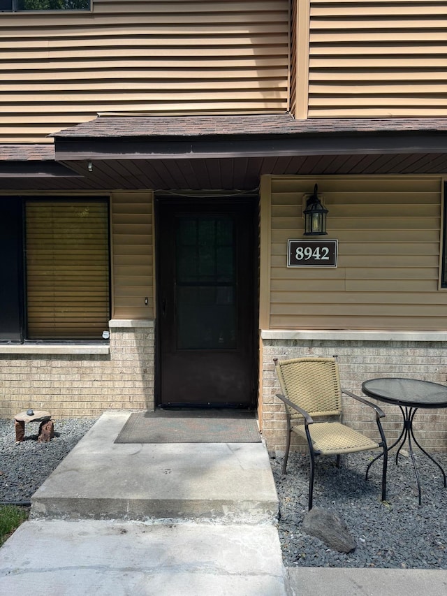 8942 Underwood Ln N, Maple Grove, MN 55369 - property entrance featuring brick siding and a porch