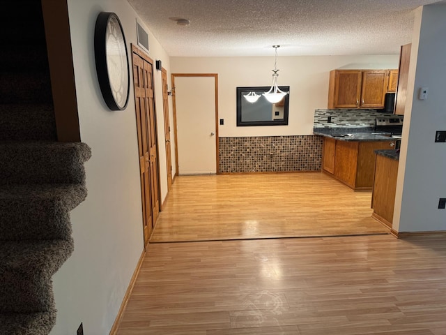 8942 Underwood Ln N, Maple Grove, MN 55369 - hall with light wood-style flooring, a textured ceiling, and baseboards