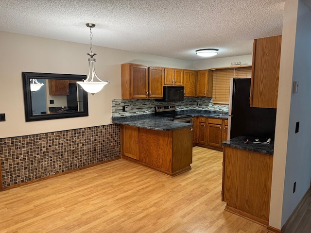8942 Underwood Ln N, Maple Grove, MN 55369 - kitchen with appliances with stainless steel finishes, brown cabinetry, a peninsula, light wood-style floors, and pendant lighting