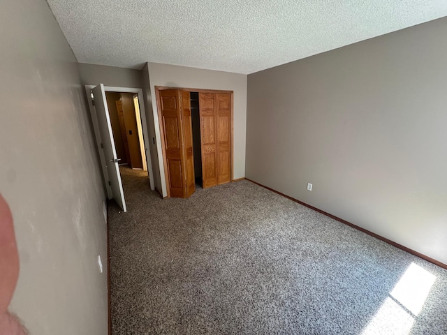 8942 Underwood Ln N, Maple Grove, MN 55369 - unfurnished bedroom with a closet, carpet flooring, a textured ceiling, and baseboards