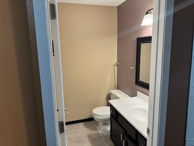 8942 Underwood Ln N, Maple Grove, MN 55369 - half bath with tile patterned floors, vanity, and toilet
