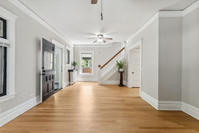 1744 Marshall Ave, Saint Paul, MN 55104 - foyer featuring a ceiling fan, ornamental molding, stairs, light wood-style flooring, and baseboards
