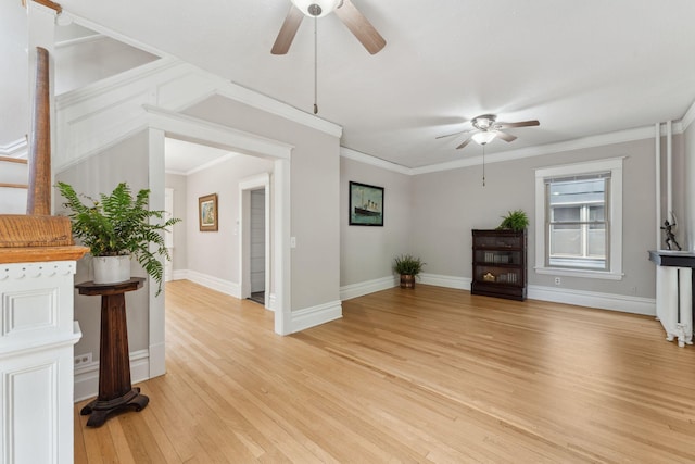 1744 Marshall Ave, Saint Paul, MN 55104 - unfurnished living room featuring ceiling fan, light wood-style floors, baseboards, and crown molding