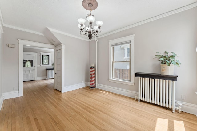 1744 Marshall Ave, Saint Paul, MN 55104 - empty room featuring a chandelier, light wood-style flooring, plenty of natural light, ornamental molding, and radiator heating unit