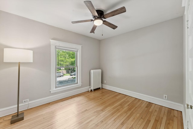 1744 Marshall Ave, Saint Paul, MN 55104 - spare room with radiator, baseboards, hardwood / wood-style flooring, and ceiling fan