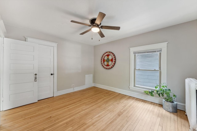 1744 Marshall Ave, Saint Paul, MN 55104 - empty room featuring wood-type flooring, a ceiling fan, radiator, and baseboards