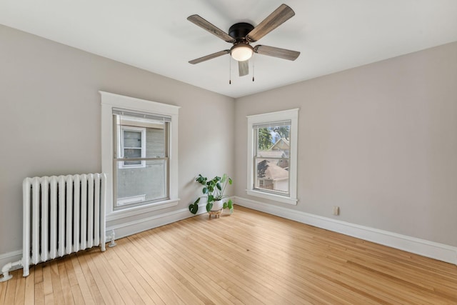 1744 Marshall Ave, Saint Paul, MN 55104 - spare room with radiator heating unit, baseboards, hardwood / wood-style floors, and a ceiling fan