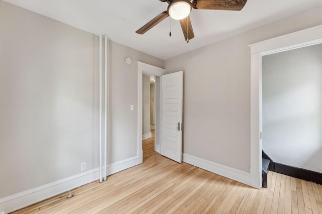 1744 Marshall Ave, Saint Paul, MN 55104 - unfurnished bedroom with hardwood / wood-style flooring, baseboards, and ceiling fan
