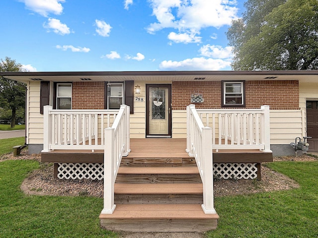 288 Locust St, Dawson, MN 56232 - view of front facade featuring brick siding and a front lawn