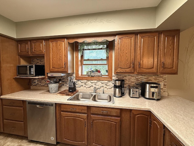 288 Locust St, Dawson, MN 56232 - kitchen with stainless steel appliances, a sink, light countertops, decorative backsplash, and brown cabinets