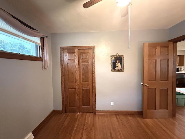 288 Locust St, Dawson, MN 56232 - empty room featuring wood finished floors, baseboards, and a ceiling fan