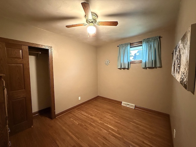 288 Locust St, Dawson, MN 56232 - unfurnished bedroom with wood finished floors, baseboards, and ceiling fan