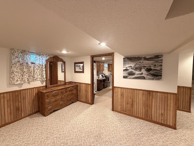 288 Locust St, Dawson, MN 56232 - hall with wainscoting, a textured ceiling, wood walls, and carpet