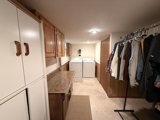 288 Locust St, Dawson, MN 56232 - laundry area featuring independent washer and dryer, cabinet space, light floors, and a textured ceiling